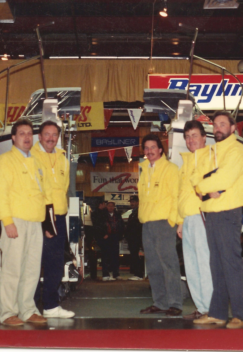 1991 - Paul Brazeau and sales staff stand in front of their display of a boat cut in half